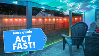 Porch awning featuring Govee string lights illuminating plastic adirondack chairs in a blue glow and wooden fence with hanging smart lights behind Act Fast badge