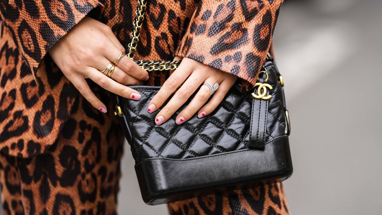 Valentine&#039;s Day nails - heart manicure holding Chanel bag