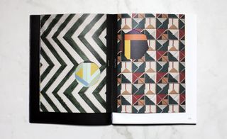 Open pages in the book showcasing geometric design patterns