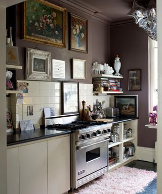 traditional kitchen with purple walls and stainless steel oven