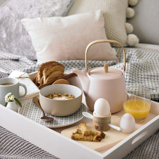 bed with serving tray and breakfast