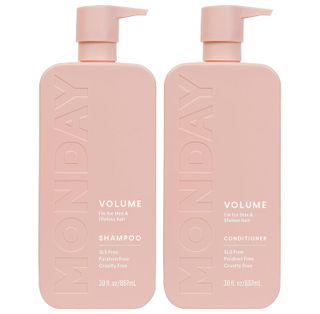 pink bottles of monday shampoo and conditioner