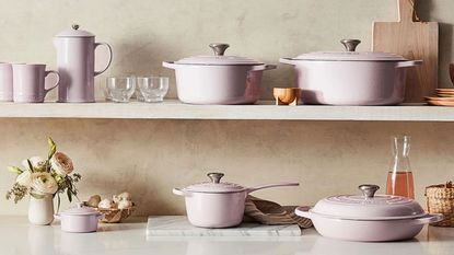 The complete Le Creuset Shallot set of pans and lids across a countertop and shelf.