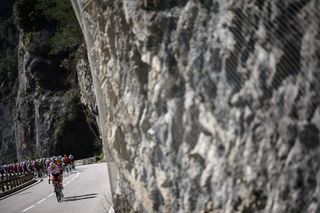 TotalEnergies' French rider Thomas Gachignard wearing the climber's dotted jersey cycles ahead of the pack of riders (peloton) during the 8th and final stage of the Paris-Nice cycling race, 119,9 km between Nice and Nice, on March 16, 2025. (Photo by Anne-Christine POUJOULAT / AFP)