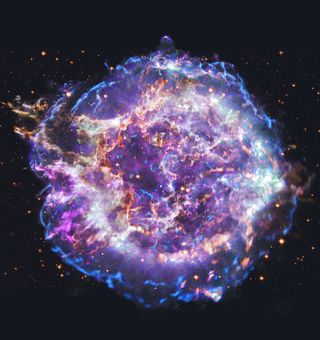 A chaotic purple and blue stellar remnant against the backdrop of space. White and yellow accents make it appear to glow on the screen.