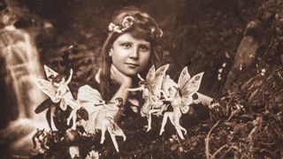 ENGLAND : A photograph of Frances 'Alice' Griffiths (1907-1986) taken by her cousin Elsie 'Iris' Wright (1901-1988), using her father Arthur's Midg quarter-plate camera, the first in the 'Cottingley Fairies' series. Frances, posed in the family garden, stares into the camera past dancing fairies, one of whom plays a pipe. A small waterfall tumbles into a 'beck', beyond. The fairies were actually drawings by Elsie, secured in the ground with hat pins. It was a secret the girls decided to keep until the 1980s - once they realised the extent of the deception - to protect the public reputations of those who believed in the 'truth' of the images. Alice was probably the name given to Frances by Sir Arthur Conan Doyle (1859-1930) in an attempt to conceal the girls' identities when he published the photographs. (Photo by SSPL/Getty Images)