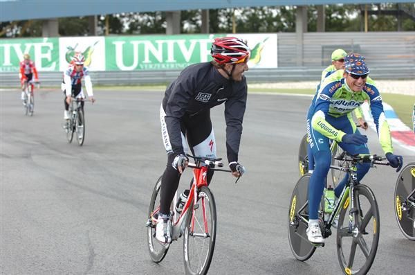 Fabian Cancellara (Saxo Bank) chats to the Liquigas team as he makes his way around the circuit