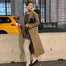 Fashion person Aisha Farida wears a coloured tight outfit. She wears white tights.