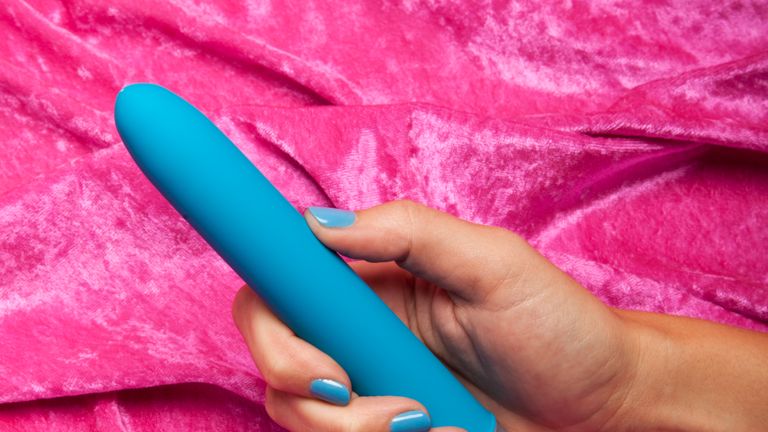 Young Woman Holding Vibrator - stock photo