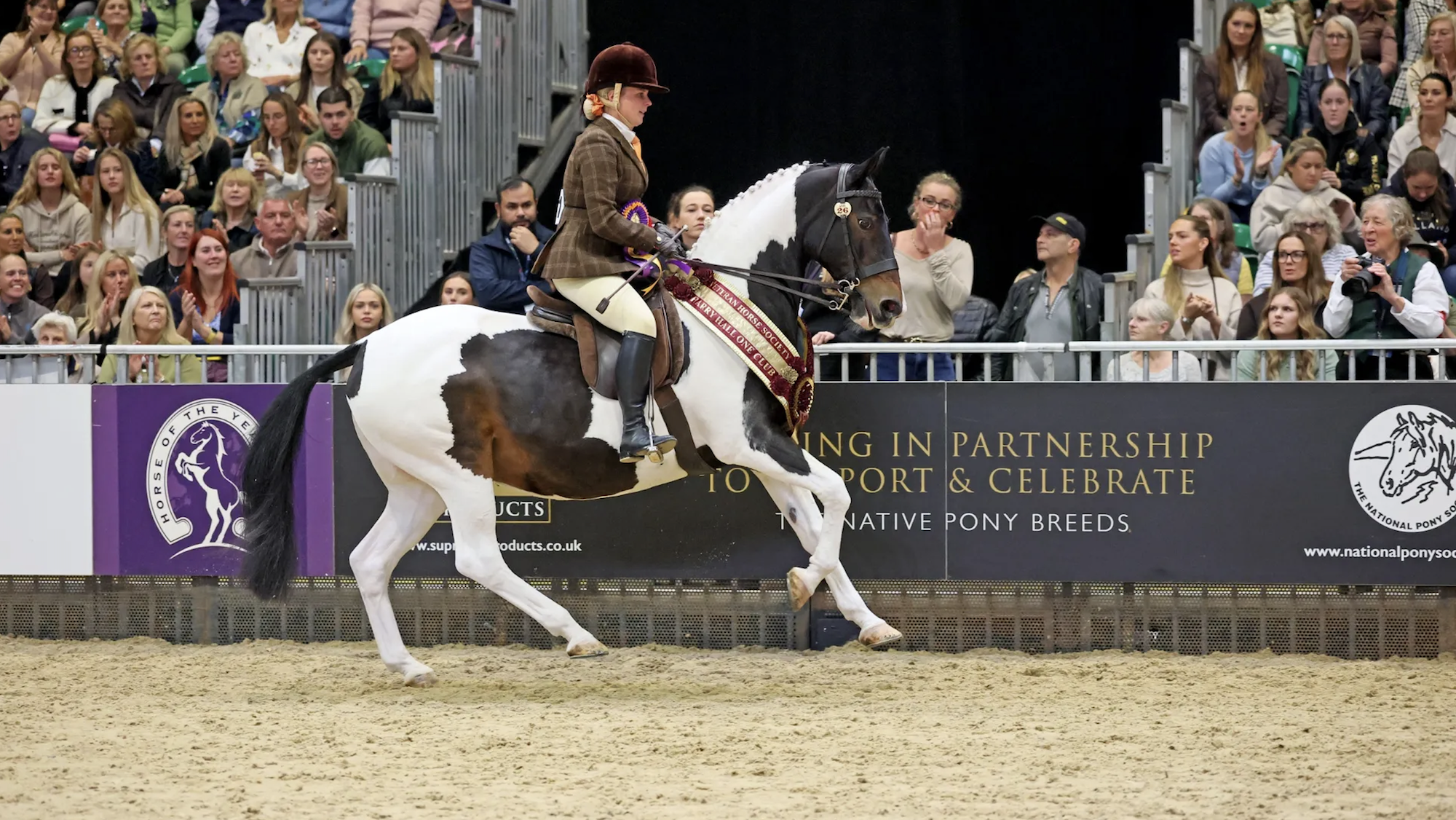Shemika Snip and Kelsey Bishop canter out of the ring at HOYS 2026