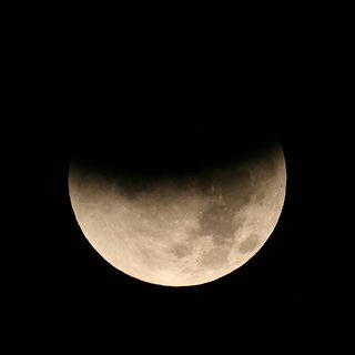 An example of how the partial eclipse of the Moon on June 4, 2012 may appear to the naked eye or through binoculars at maximum eclipse.