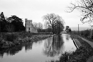 River with a church in the background in the Cotswolds taken on Ilford XP2 Super 35mm film