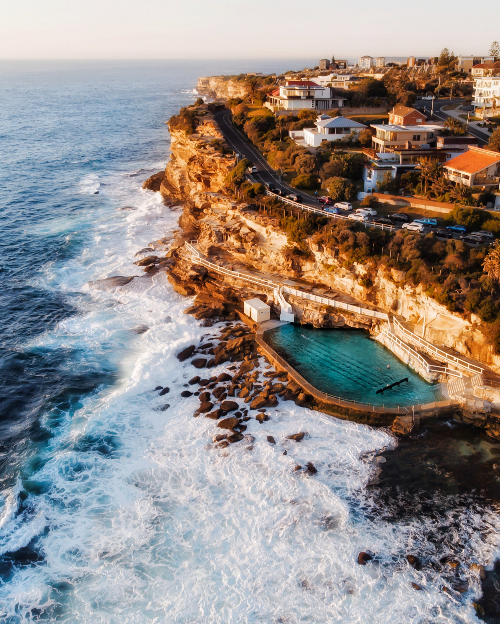 An aerial view of a beach pool at sunset.