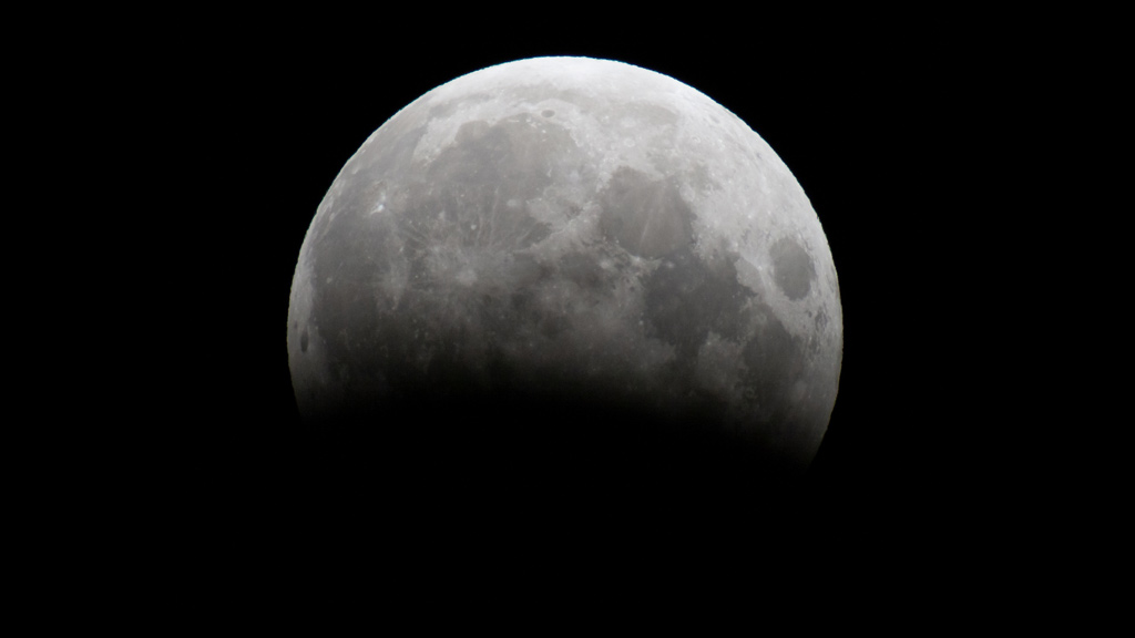 A partial lunar eclipse on June 3 and 4, 2012, served as a prelude to the transit. This photo shows the eclipse at maximum, with about 30% of the moon's face immersed in the Earth's umbral shadow.