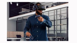 Image shows a man using the HTC Vive Pro 2 in an office.