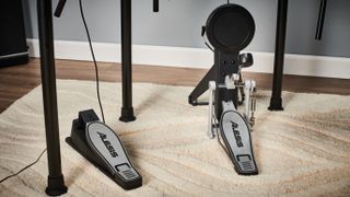 5 reasons why Black Friday is the best time to buy an electronic drum set: Close up of Alesis hi-hat and bass drum pedals on a cream coloured rug