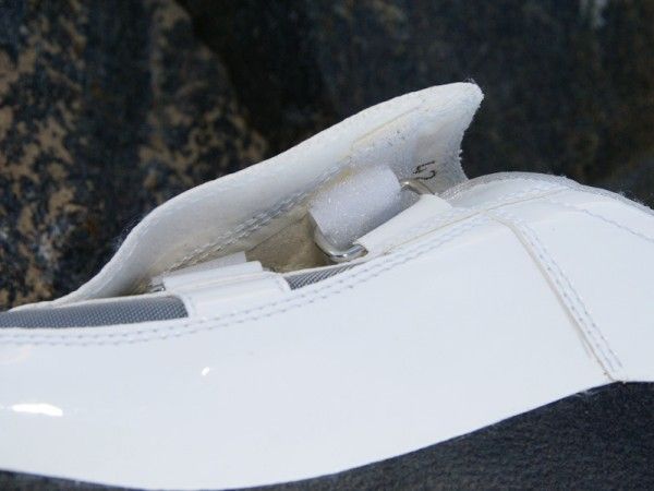 The strap cover looks a bit odd and the hook-and-loop portions don't line up well - both bad signs for a shoe that costs 475 Euros.