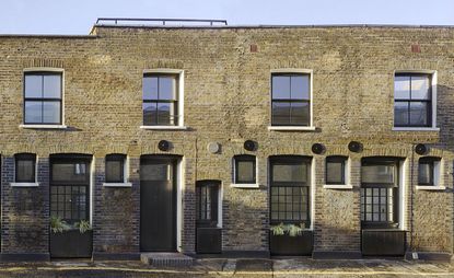 Four small mews houses with brick walls