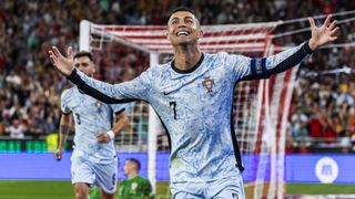 Cristiano Ronaldo celebrates his 900th career goal in a blue and white Portugal top.