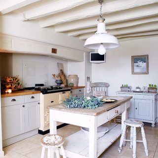 kitchen with white cabinets wooden table ceiling lamp