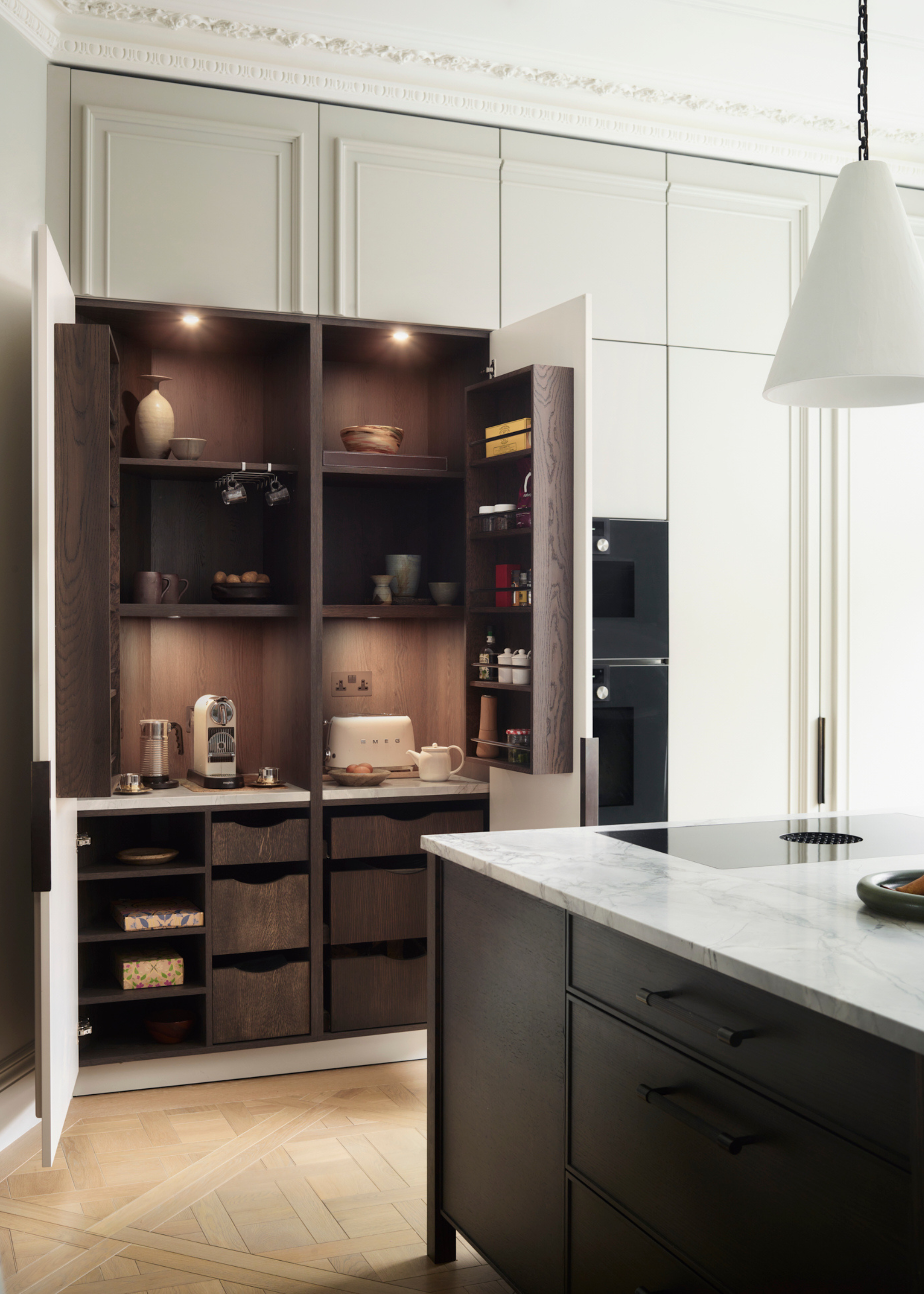sleek breakfast bar with dark wooden interiors and coffee machine within