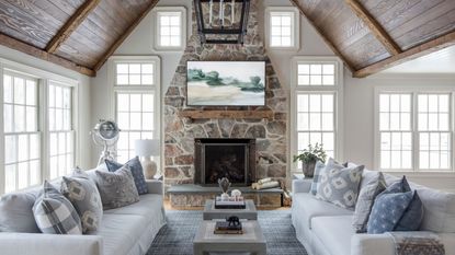 Living room with apex ceiling and stone clad fireplace