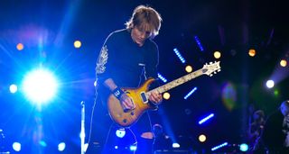 Keith Urban plays a semi-hollow PRS onstage in Nashville, 2024. He is currently developing a new signature model with the Maryland-based high-end guitar company.