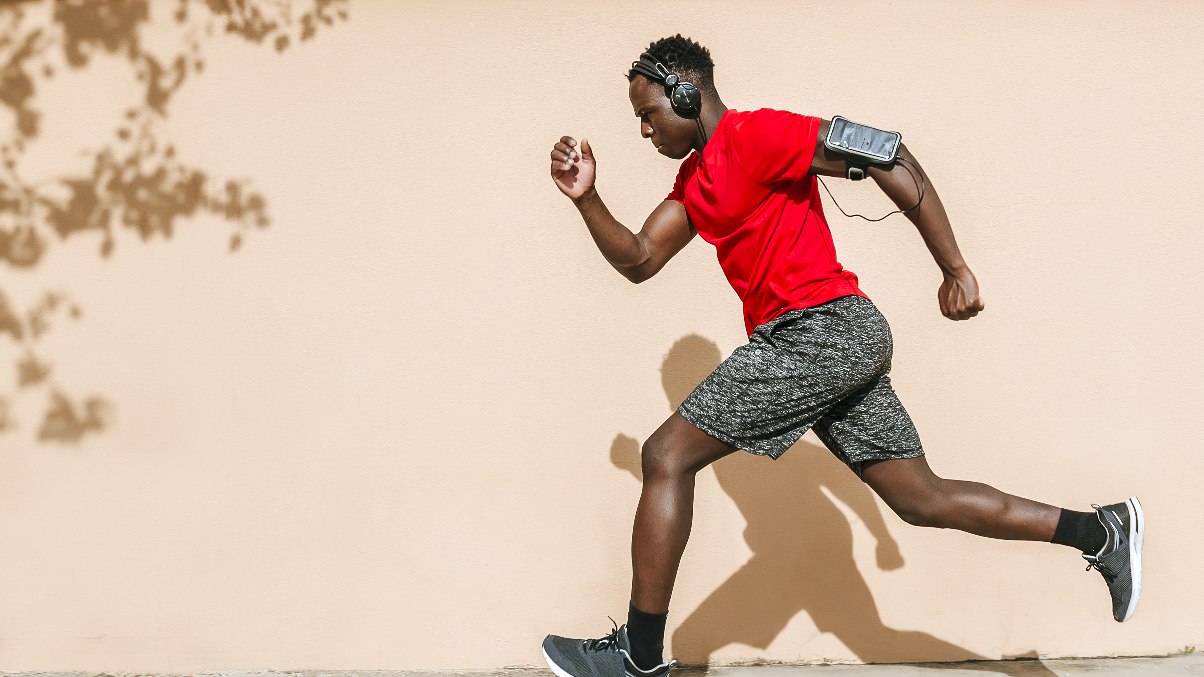 A man running outside with headphones on