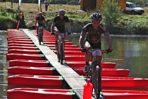 Racers cross a floating bridge.