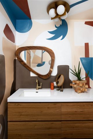 A bathroom with mural-style wallpaper