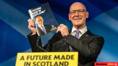 John Swinney holds the SNP manifesto aloft at its launch in Edinburgh (Photographer: Emily Macinnes/Bloomberg via Getty Images)