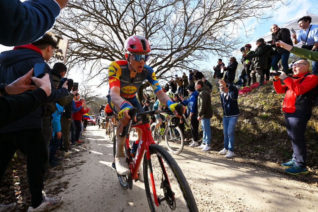SIENA ITALY MARCH 02 Toms Skujins of Latvia and Team Lidl Trek competes while fans cheer during the 18th Strade Bianche 2024 Mens Elite a 215km one day race from Siena to Siena 320m UCIWT on March 02 2024 in Siena Italy Photo by Tim de WaeleGetty Images