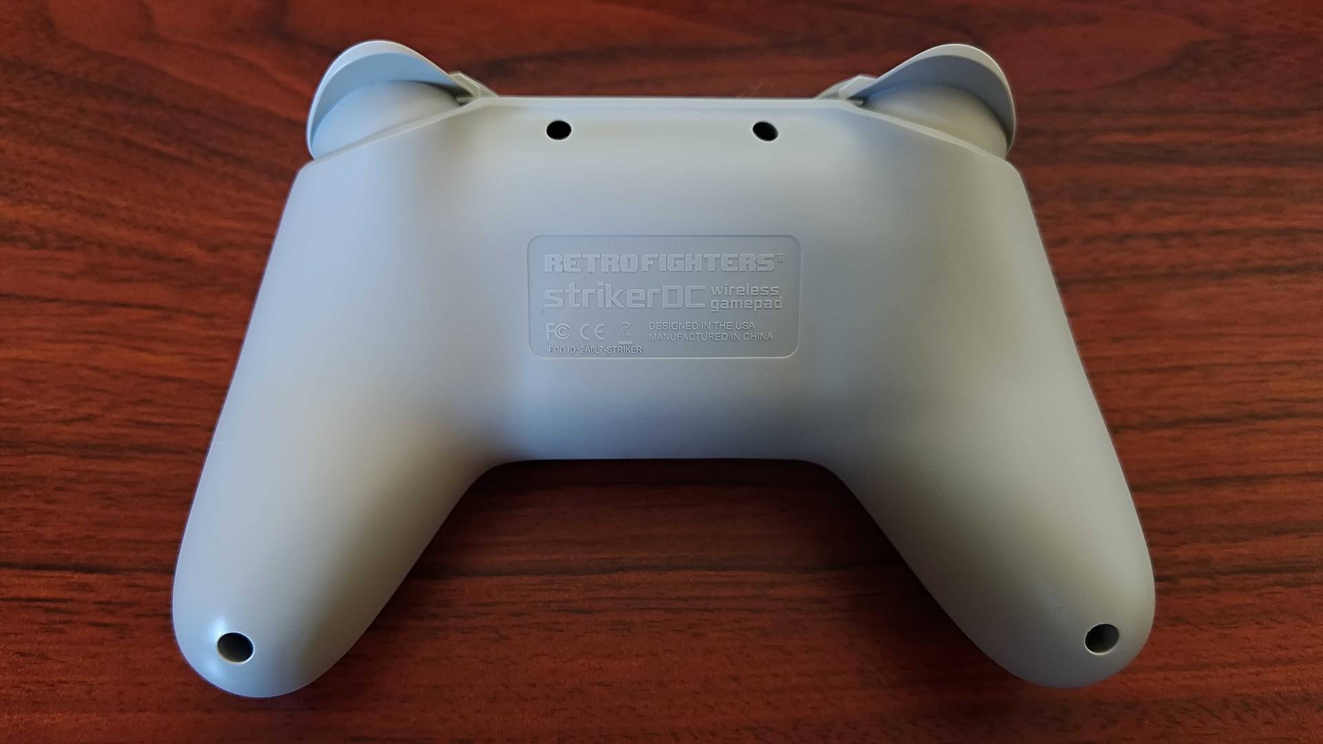 Back view of Retro Fighters StrikerDC on woodgrain desk.