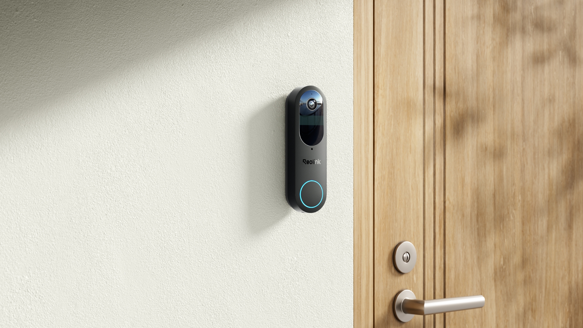 Reolink Battery Doorbell installed on a white wall next to wooden door