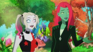 Harley and Poison Ivy looking happy at something happening off-screen in Harley Quinn