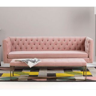 Julienne 3-seater Velvet Sofa in blush pink and Julianne blush pink ottoman against Grey Wall