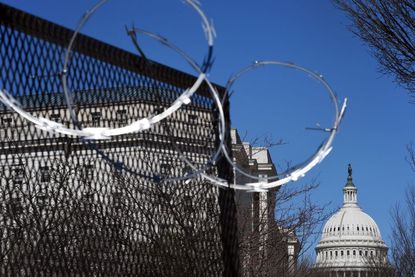 Barbed wire surrounding Capitol.
