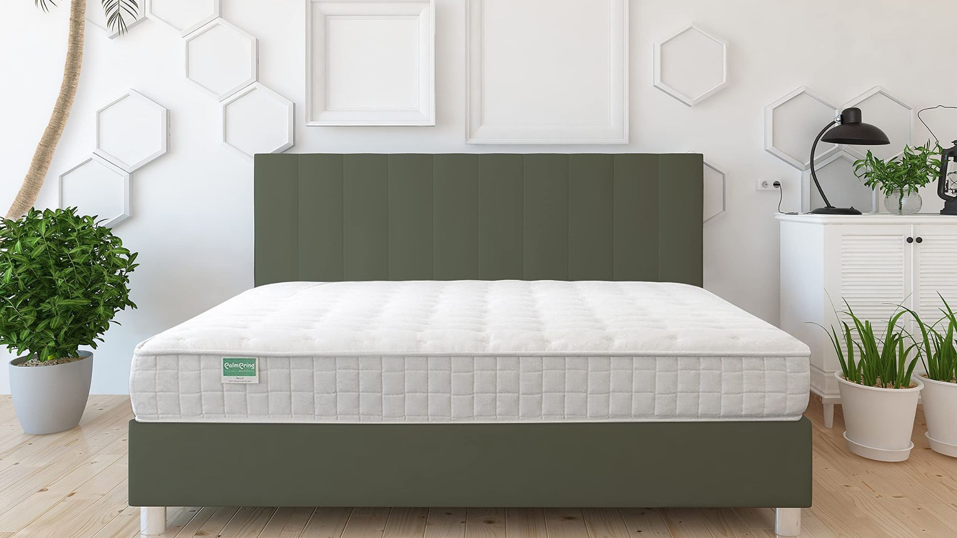 The Palmpring Cambay mattress made from coir on a green bed base in a spacious and brightly lit bedroom