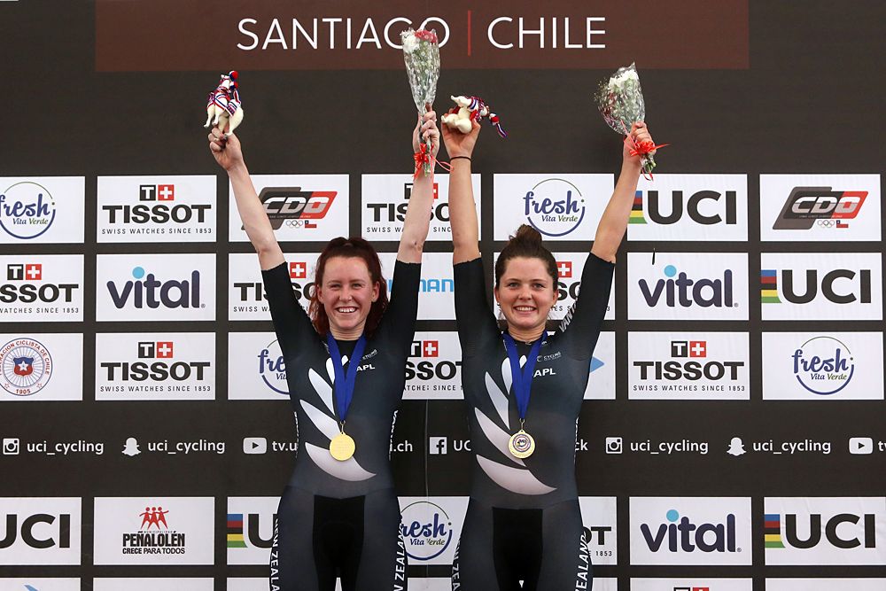 New Zealander cyclists Racquel Sheath (L) and Michaela Drummond celebrate on the podium after winning the women's Madison final race, during the Tissot UCI Track Cycling World Cup