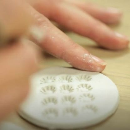 hand with dry clay decoration