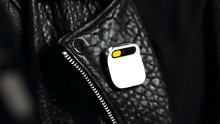 An image of Humane's new AI-powered magnetic pin, snapped onto a leather jacket.