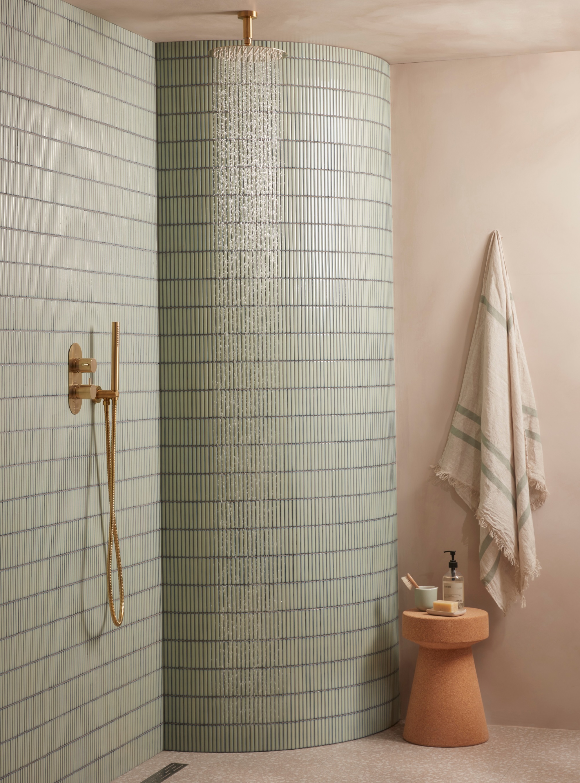 Sage green bathroom with minimalist shower system with ceiling mounted shower head