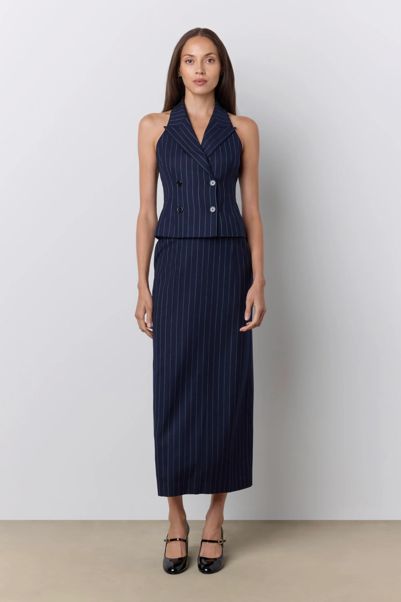 model wearing navy pinstripe vest