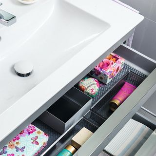 sink vanity with open drawers and make-up storage