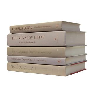 A stack of books with neutral beige covers