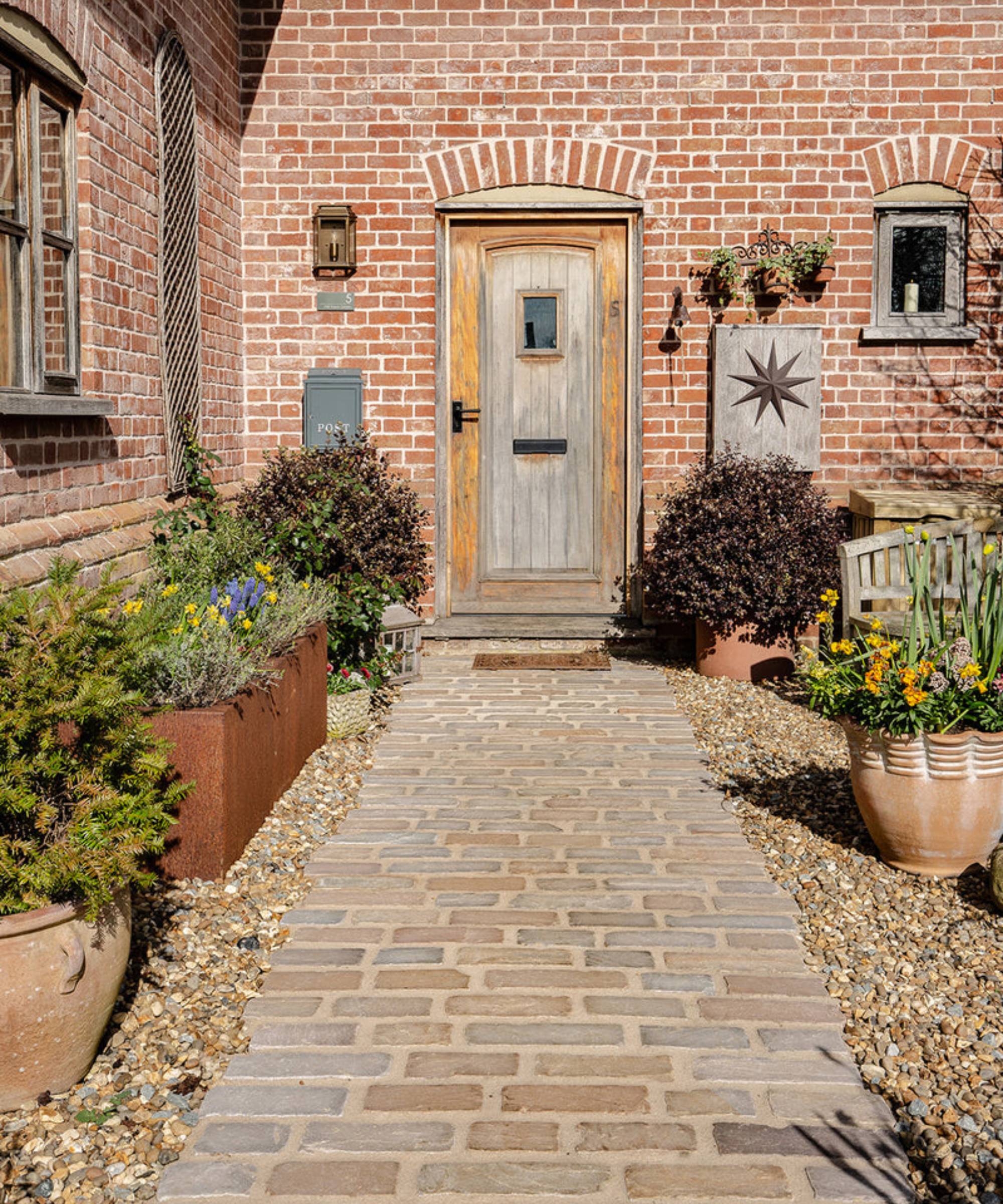 Hempstead Tumbled Sandstone Cobbles by Quorn Stone as garden path to front door