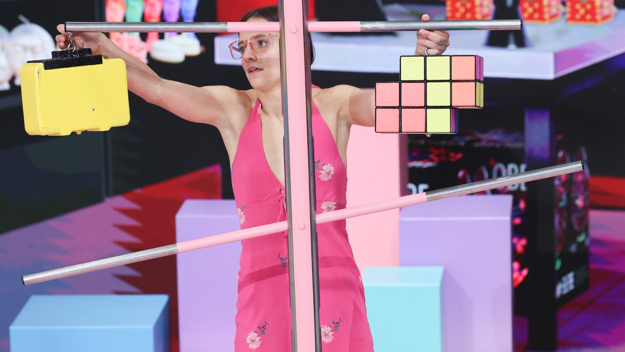 Mallory trying to balance a lot of objects during the premiere safety competition.