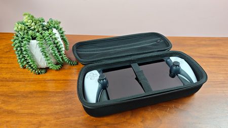 Venom PlayStation Portal Carry Case with PS Portal and plant on table