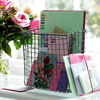 letter in metal basket and pink rose