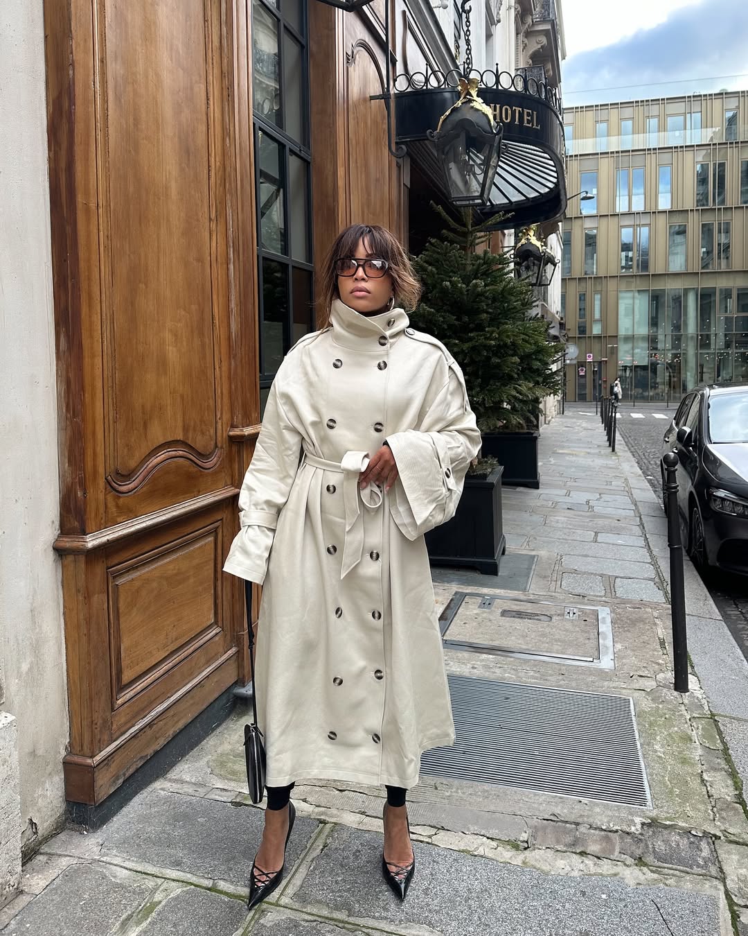 Ellie in a trench and heels